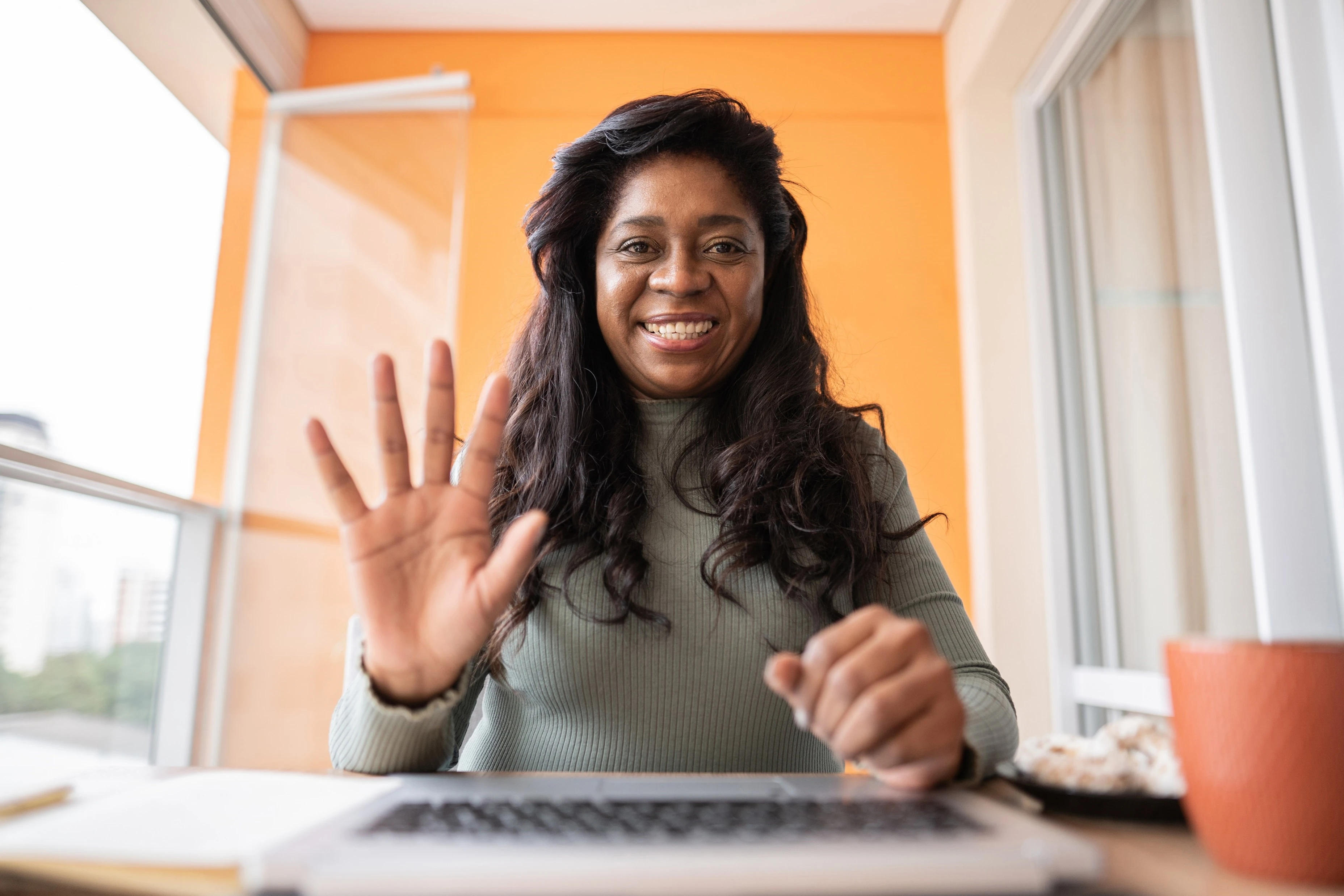 Woman waving and smiling